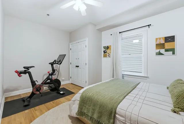 a bedroom with a bed and a chandelier