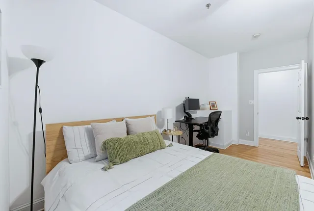 a bedroom with a bed and a chair