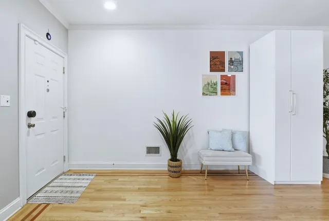 a view of room with window and wooden floor