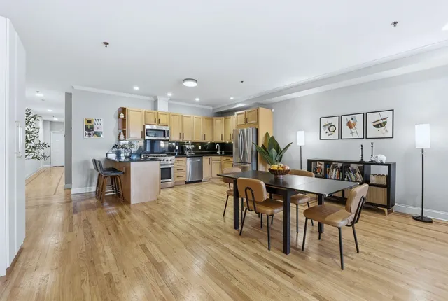 a view of a dining room with furniture and wooden floor