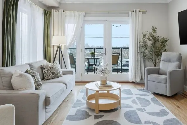 a living room with furniture and a large window