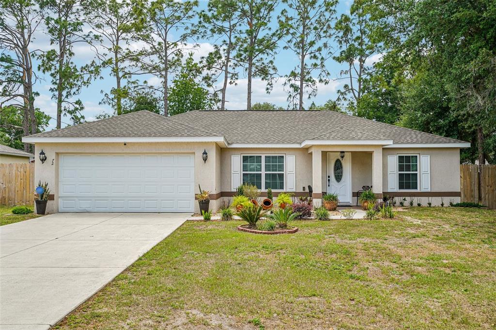72 Cedar Road Ocala, FL 34472 - Photo 1 of 20 a front view of house with yard seating and green space