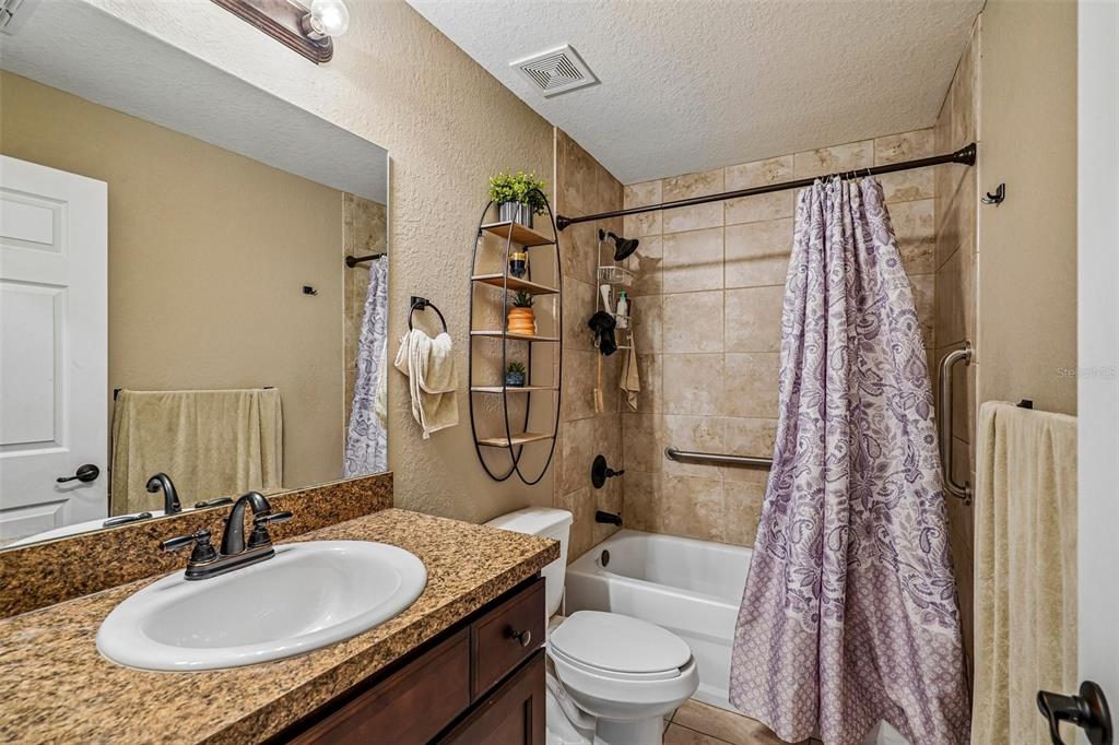 72 Cedar Road Ocala, FL 34472 - Photo 14 of 20 a bathroom with a granite countertop sink toilet and shower