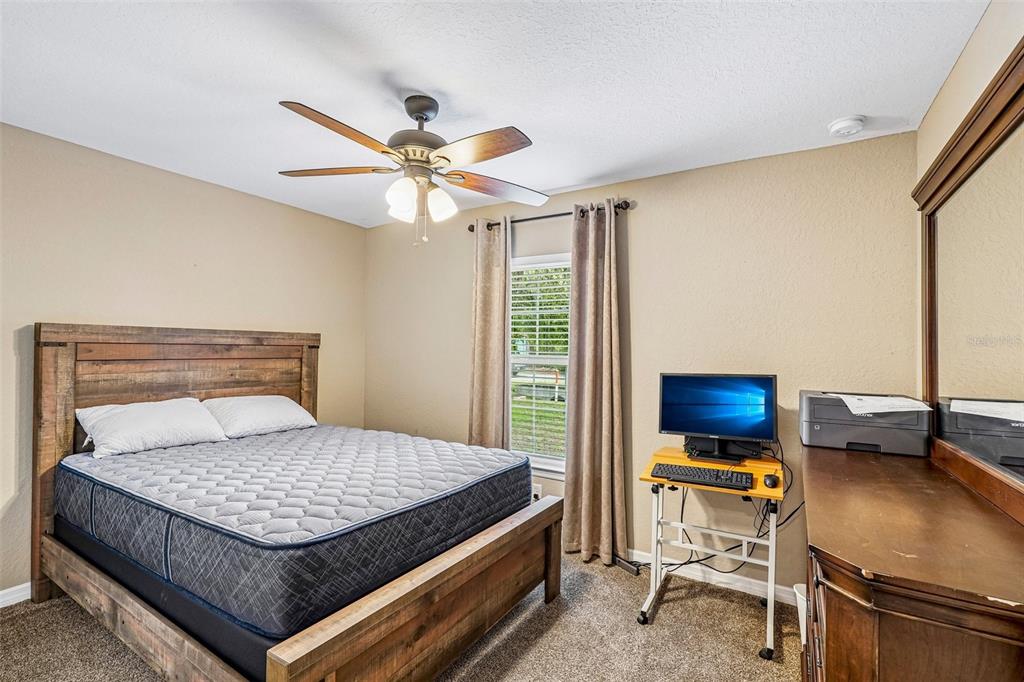 72 Cedar Road Ocala, FL 34472 - Photo 15 of 20 a bedroom with a bed and a desk