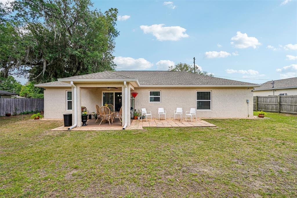 72 Cedar Road Ocala, FL 34472 - Photo 18 of 20 a front view of a house with swimming pool and porch with furniture