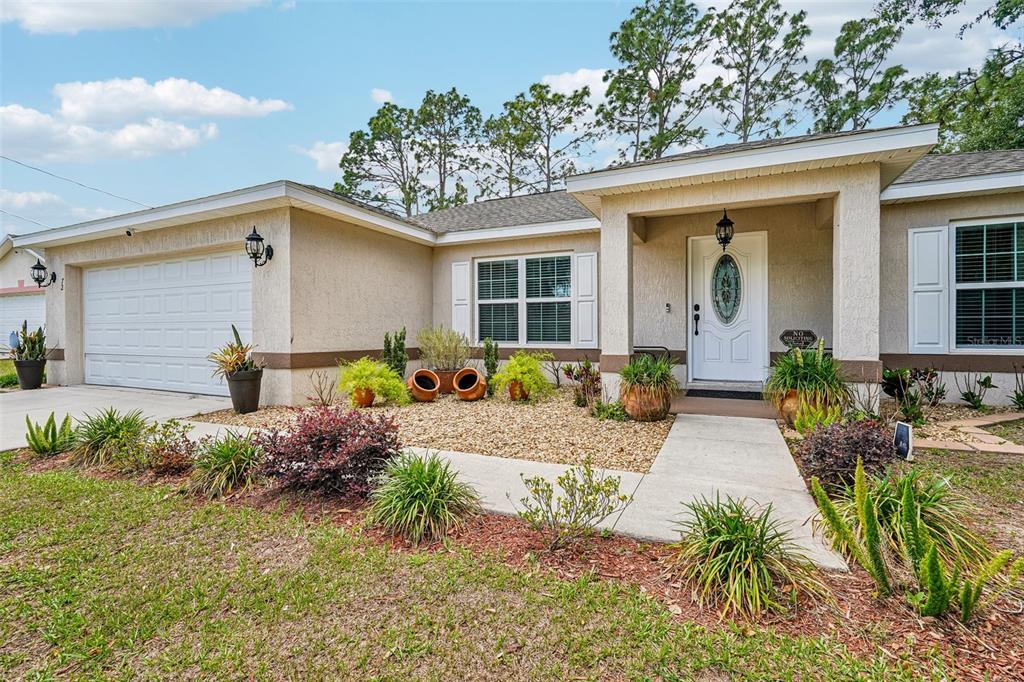 72 Cedar Road Ocala, FL 34472 - Photo 2 of 20 a front view of a house with garden