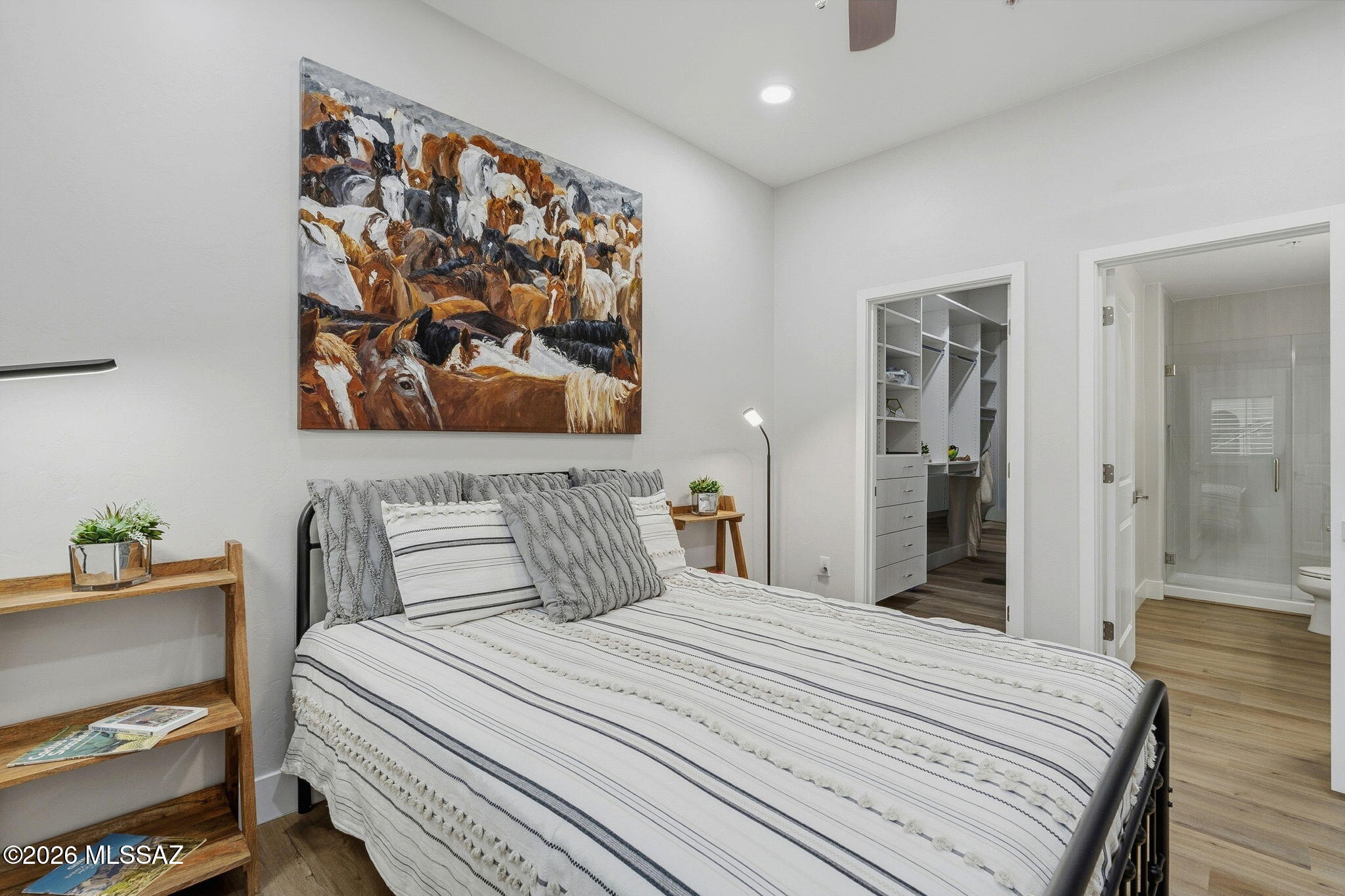 2020 East River Road, Unit 101 Tucson, AZ 85718 - Photo 10 of 12 a bedroom with a bed and painting on the wall