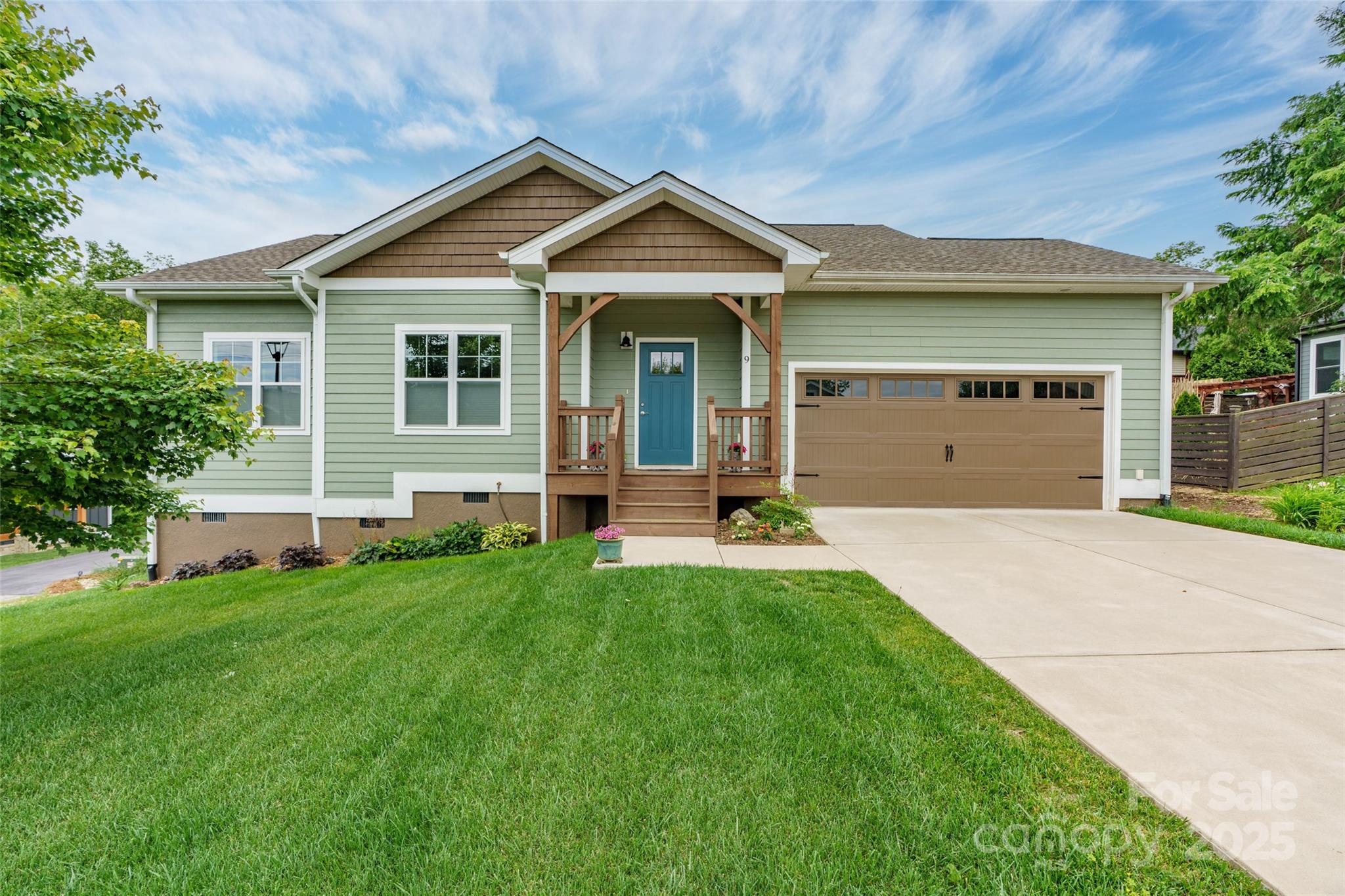 a front view of a house with a garden