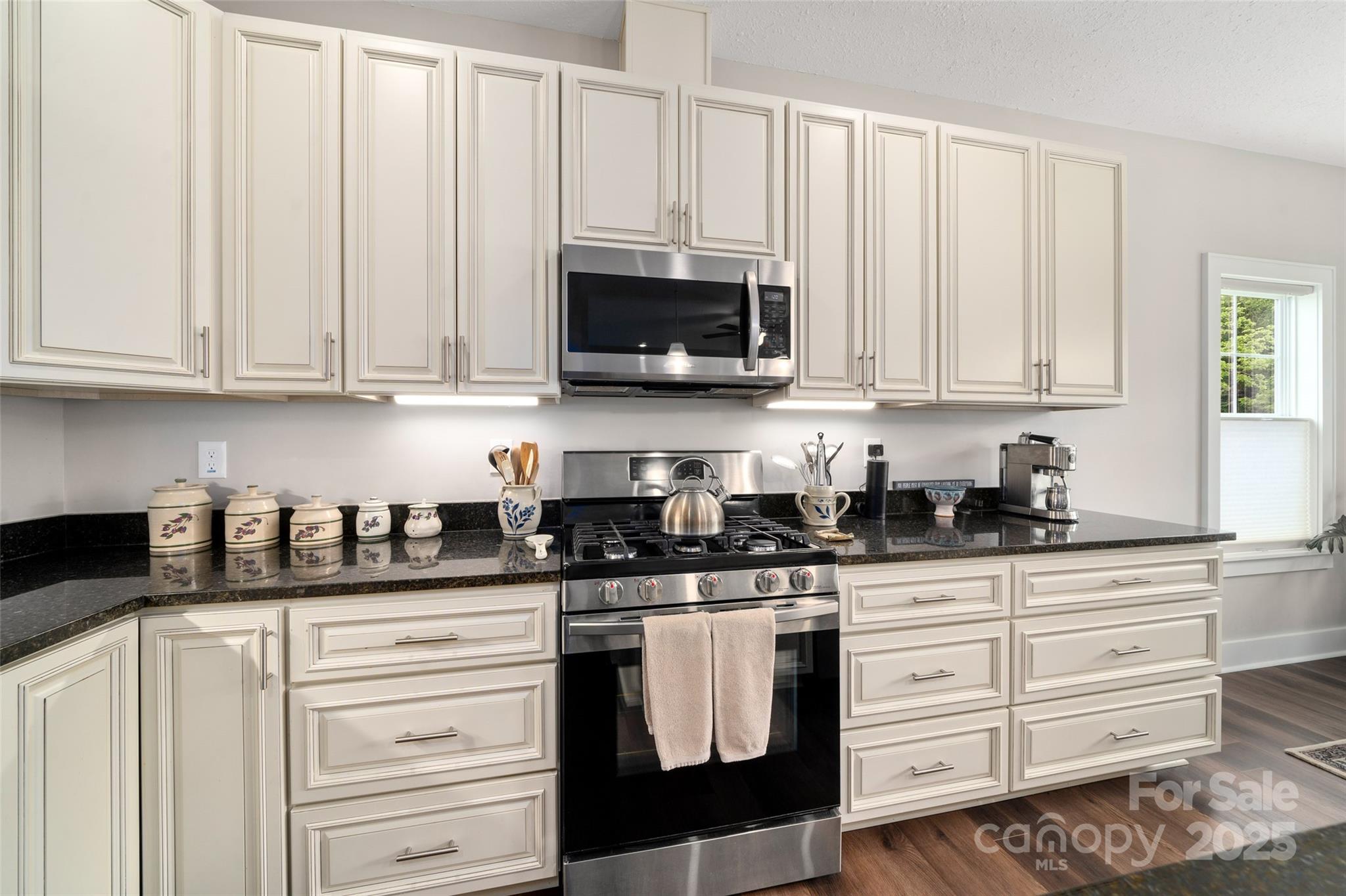 9 Vedder Way Swannanoa, NC 28778 - Photo 11 of 33 a kitchen with granite countertop white cabinets and stainless steel appliances