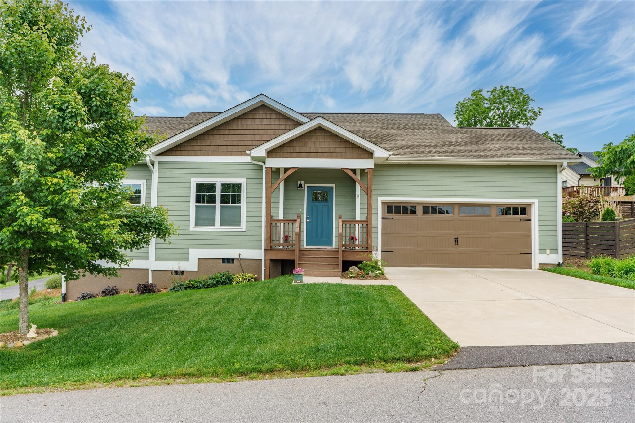 9 Vedder Way Swannanoa, NC 28778 - Photo 28 of 33 a front view of a house with a yard and garage