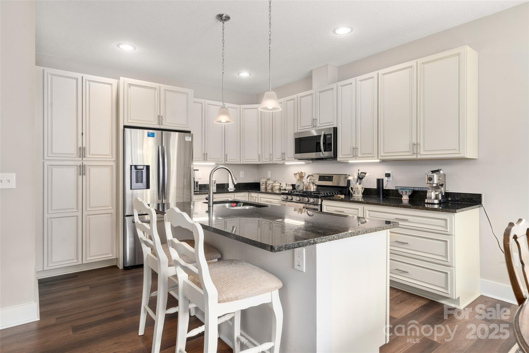9 Vedder Way Swannanoa, NC 28778 - Photo 9 of 33 a kitchen with stainless steel appliances granite countertop a refrigerator a stove a sink a dining table and chairs with wooden floor