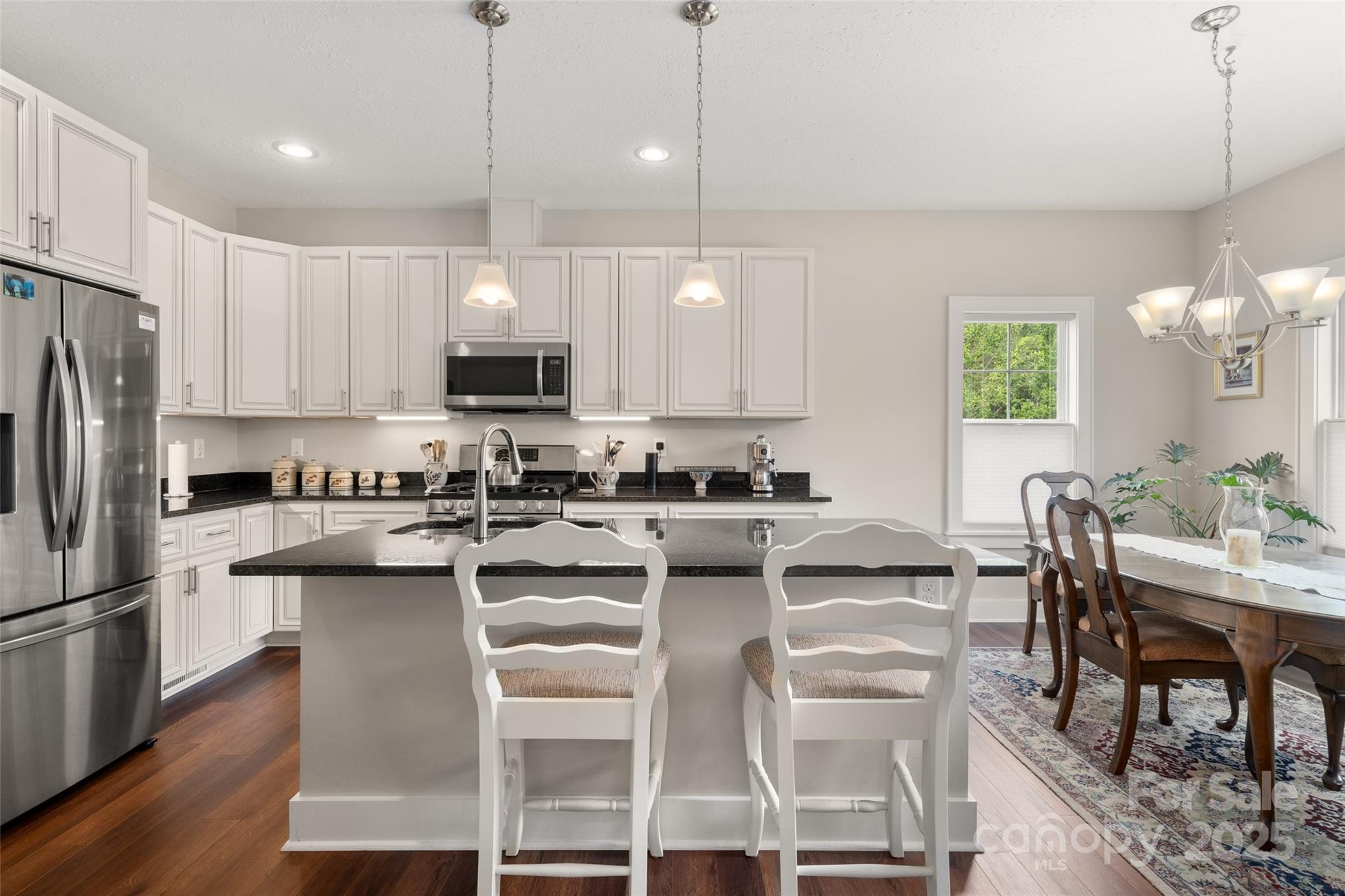 9 Vedder Way Swannanoa, NC 28778 - Photo 10 of 33 a kitchen with counter space chairs and refrigerator