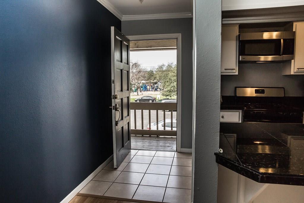 4209 Burnet Road, Unit 206 Austin, TX 78756 - Photo 3 of 20 Step into a home with a functional kitchen, featuring durable countertops and essential appliances, conveniently located near the entrance.