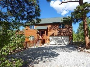 a view of a house with large trees