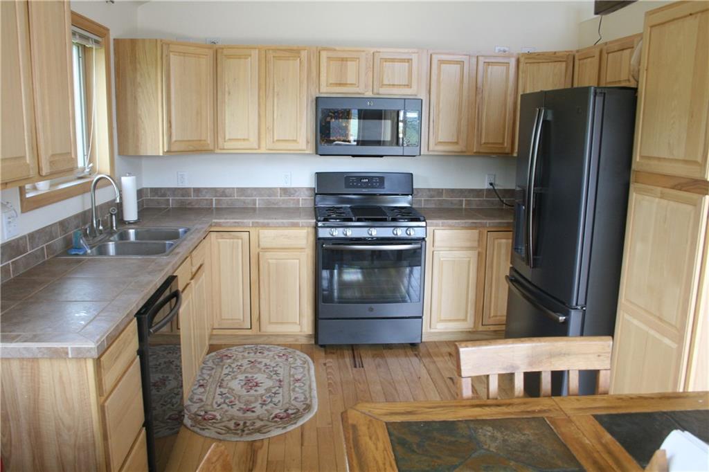 960 Sheep Ridge Road Fairplay, CO 80440 - Photo 11 of 34 a kitchen with stainless steel appliances granite countertop a stove microwave and refrigerator
