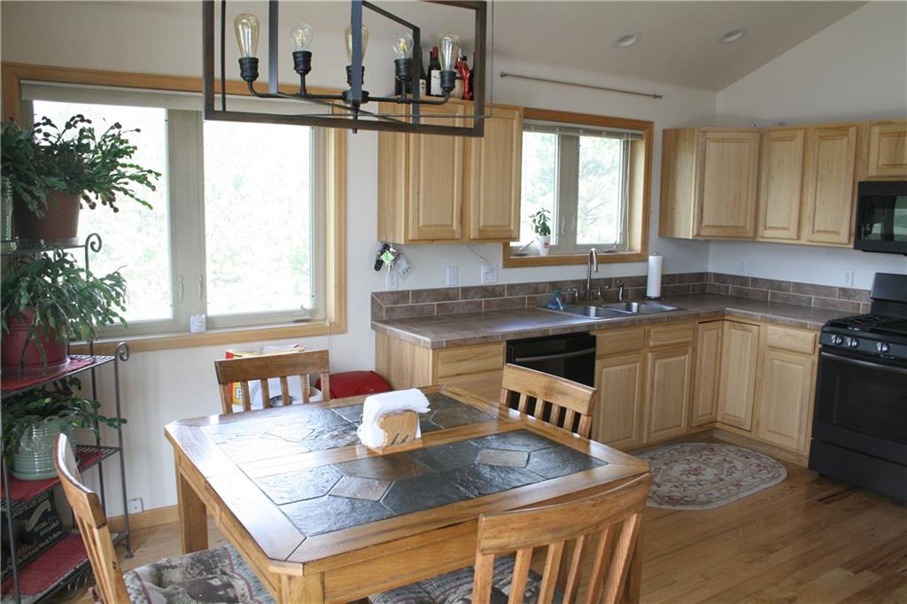 960 Sheep Ridge Road Fairplay, CO 80440 - Photo 12 of 34 a kitchen with a stove a sink a refrigerator and wooden floor