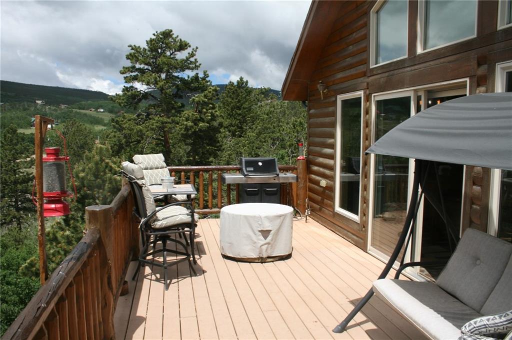 960 Sheep Ridge Road Fairplay, CO 80440 - Photo 15 of 34 a view of a patio with table and chairs and wooden floor