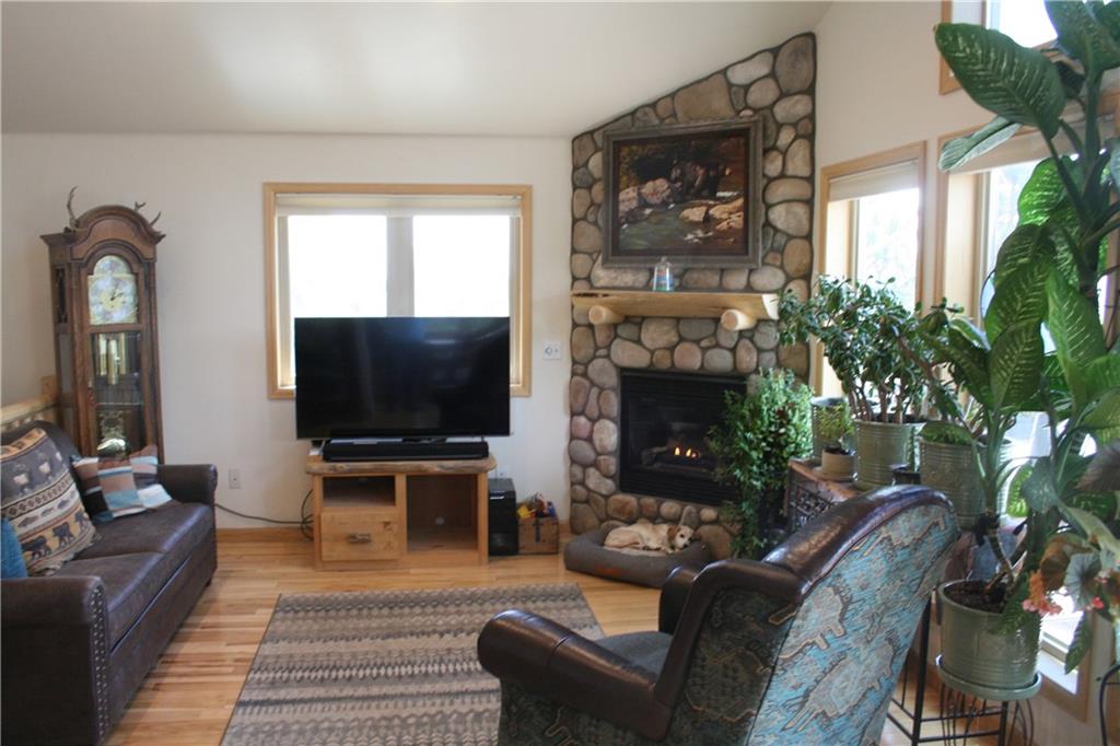 960 Sheep Ridge Road Fairplay, CO 80440 - Photo 6 of 34 a living room with furniture a flat screen tv and a fireplace
