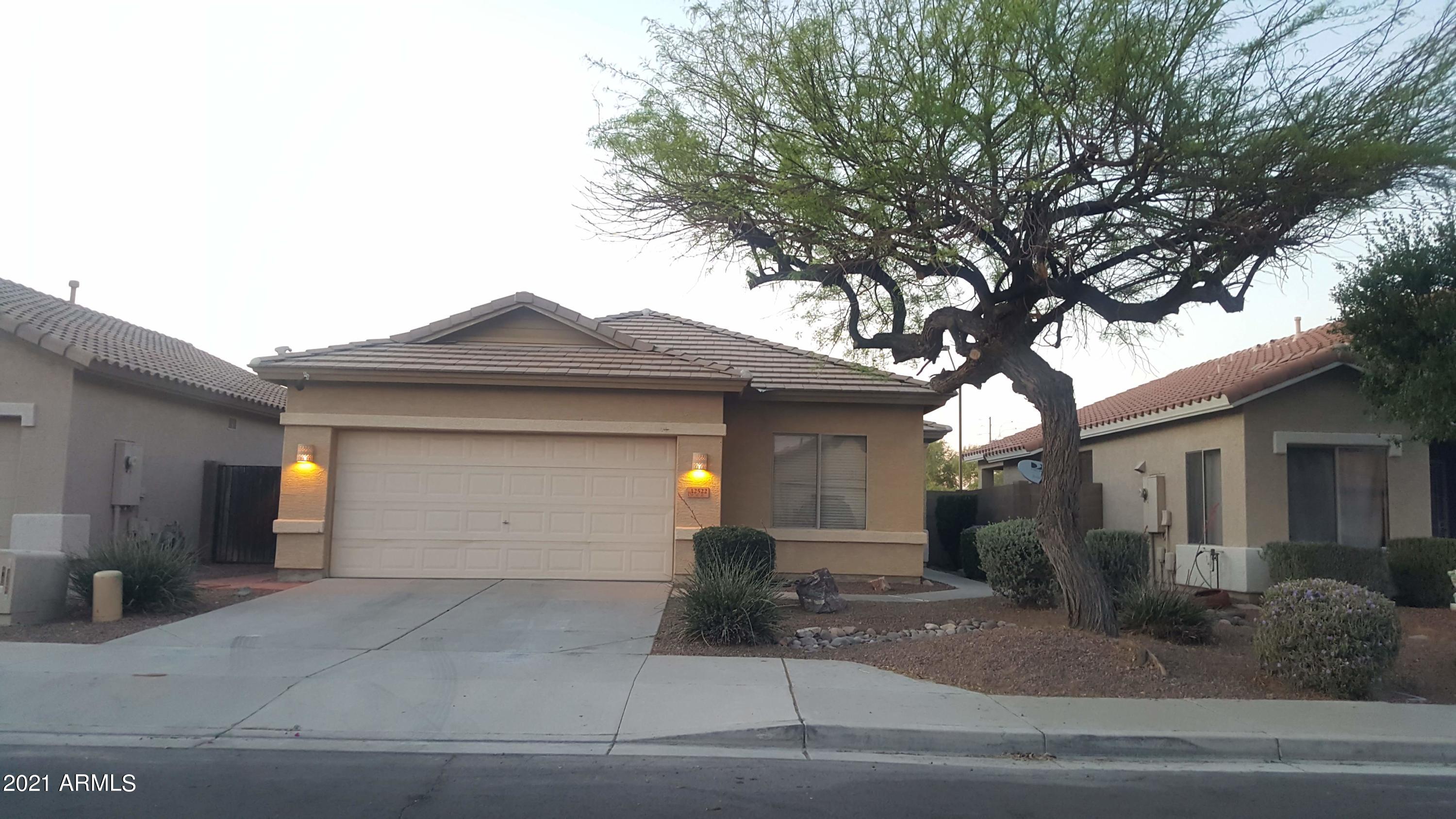 a front view of a house with garage and yard