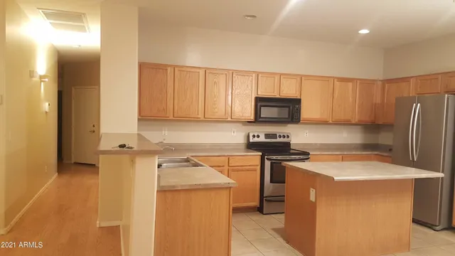 a kitchen with a sink a stove and a refrigerator