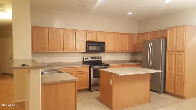 a kitchen with a sink a stove a refrigerator a washer and dryer