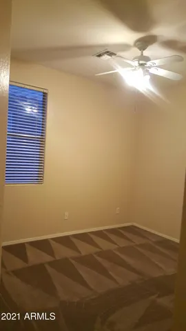 a view of a room with an empty space and a window