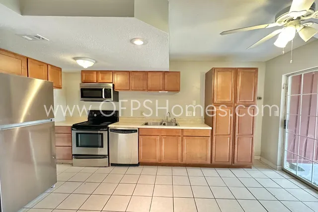 a kitchen that has a sink and a refrigerator