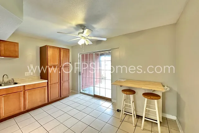 a bathroom with a sink a mirror a glass door and shower