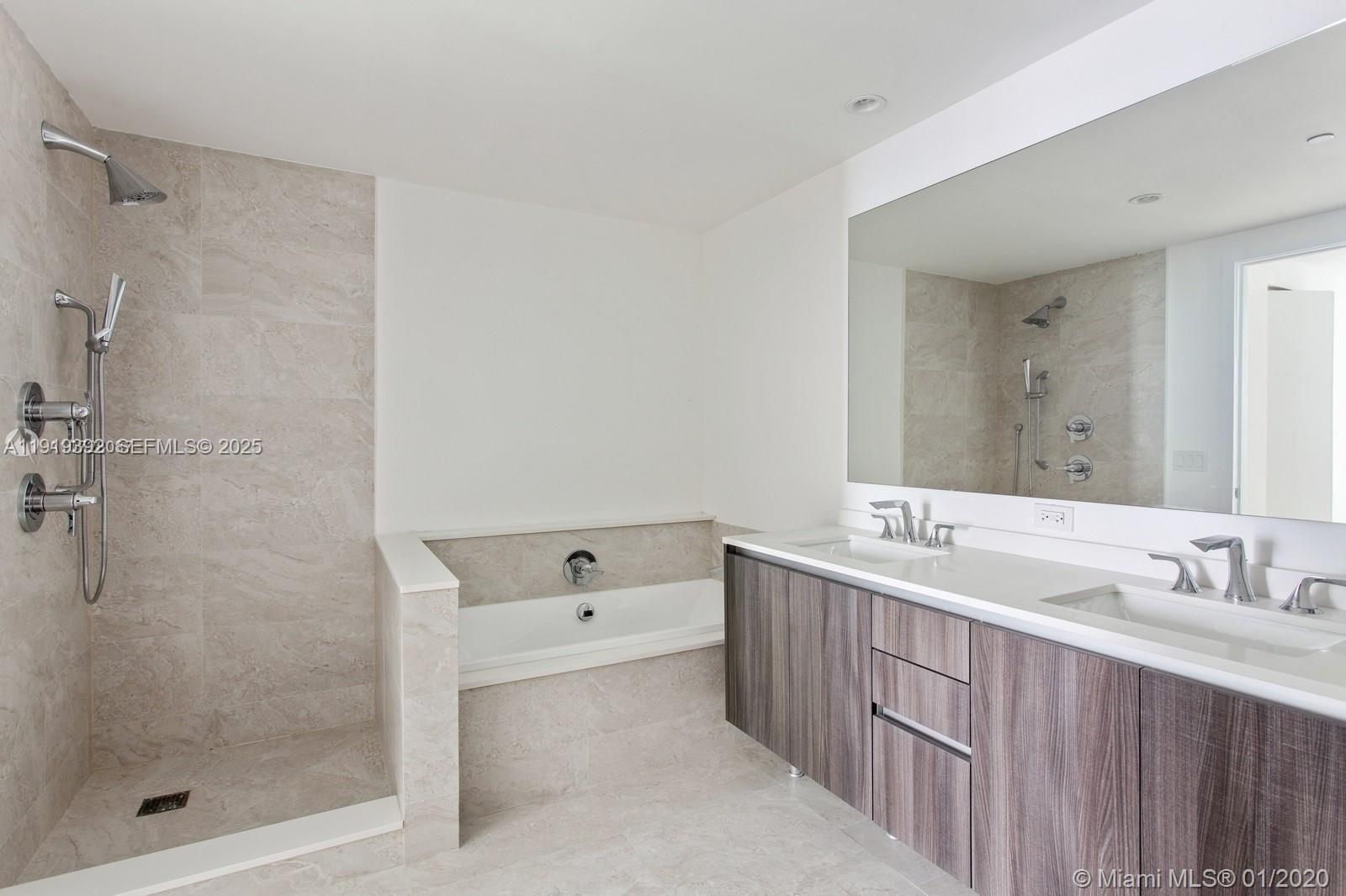 488 Northeast 18th Street, Unit 501 Miami, FL 33132 - Photo 13 of 29 a bathroom with a tub sink mirror and shower