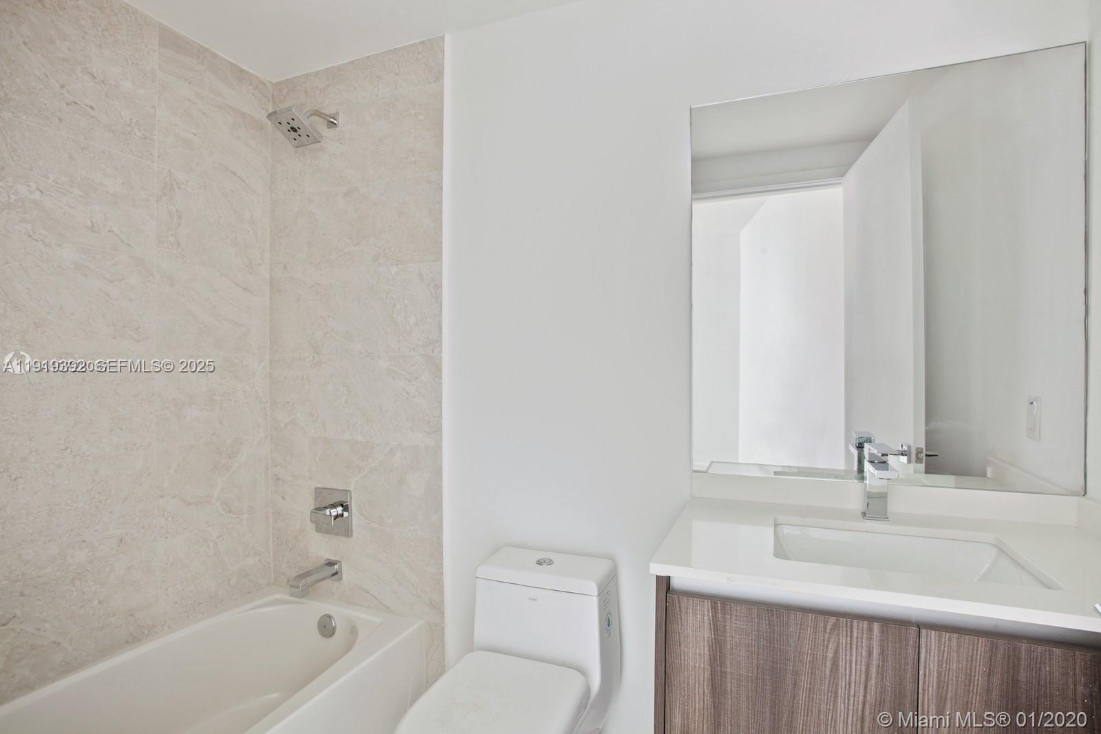 488 Northeast 18th Street, Unit 501 Miami, FL 33132 - Photo 15 of 29 a bathroom with a sink toilet and shower