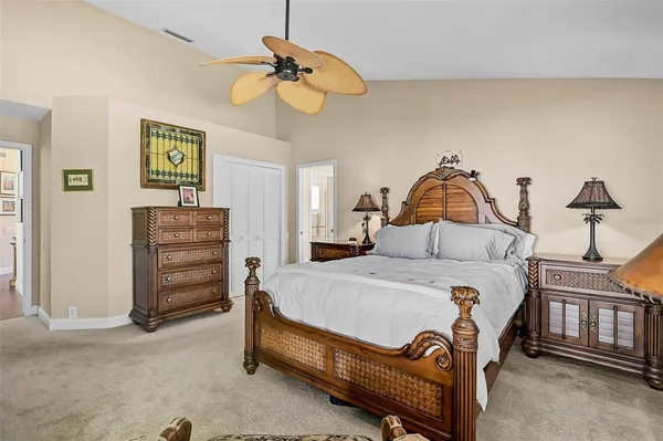 a bedroom with a bed a dresser and book shelf