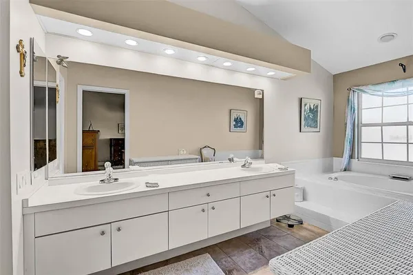 a bathroom with a double vanity sink mirror and