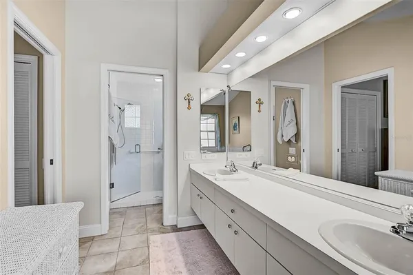 a spacious bathroom with a double vanity sink mirror and shower