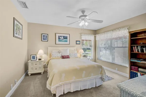 a bedroom with a bed and a bookshelf