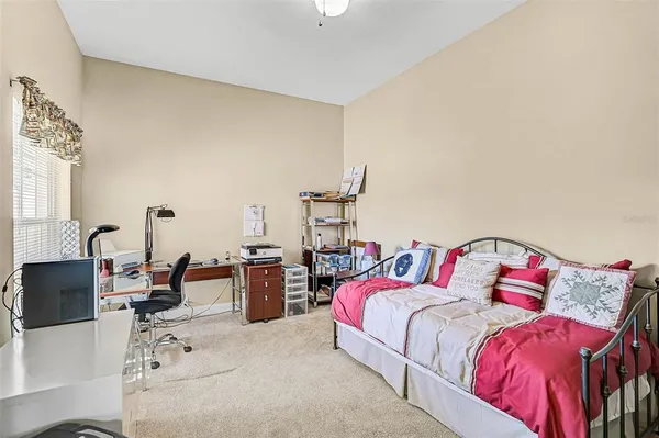 a bed room with a bed and a chair