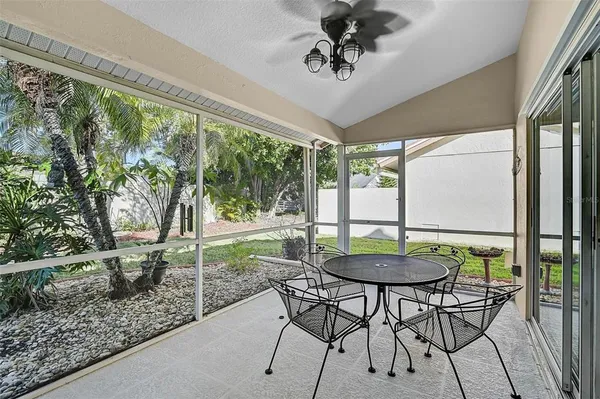 a view of a dining table and chairs in a patio