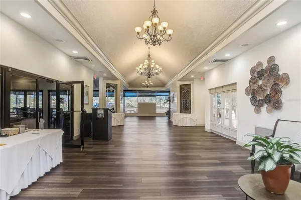 a lobby with furniture and chandelier