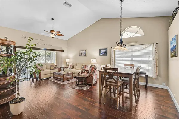 a view of a dining room with furniture window and wooden floor
