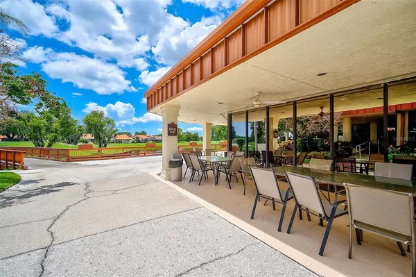 a view of a patio with dining table and chairs
