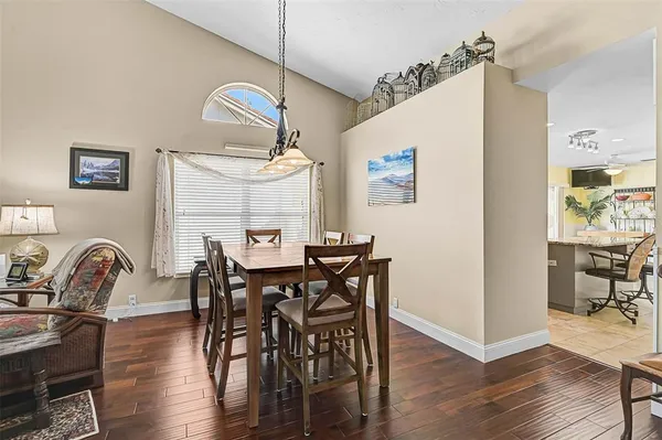 a view of a a dining room with furniture window and wooden floor