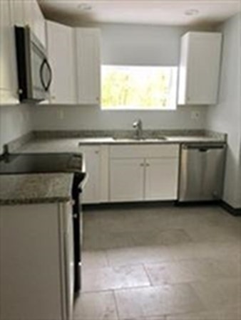 6 Lyndon Road Sharon, MA 02067 - Photo 3 of 5 a kitchen with stainless steel appliances granite countertop a sink and a stove