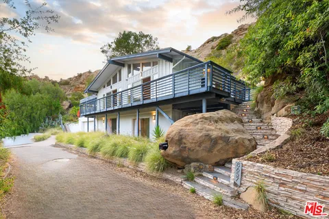 a view of a house with a yard and balcony