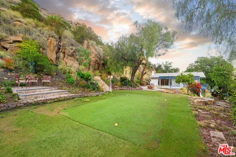 a view of a green field with clear sky