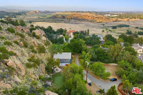 an aerial view of a house with a yard