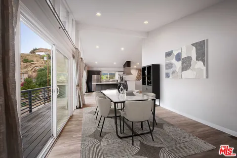 a dining room with furniture and wooden floor