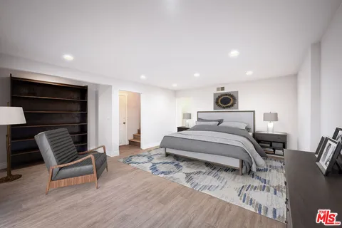 a bedroom with a bed and a chair