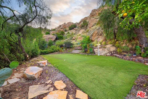 a kitchen with stainless steel appliances granite countertop a stove and a wooden floors