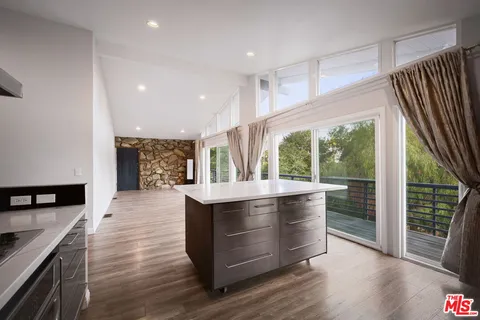 a kitchen with a sink stainless steel appliances and cabinets