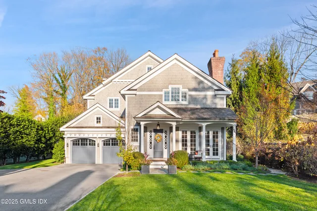 a front view of a house with a yard and porch