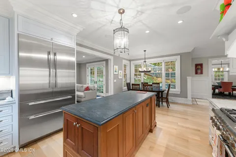 a kitchen with stainless steel appliances granite countertop a stove and cabinets